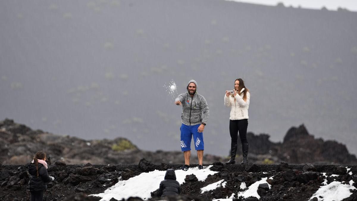 Dos turistas, entre el granizo en Timanfaya.