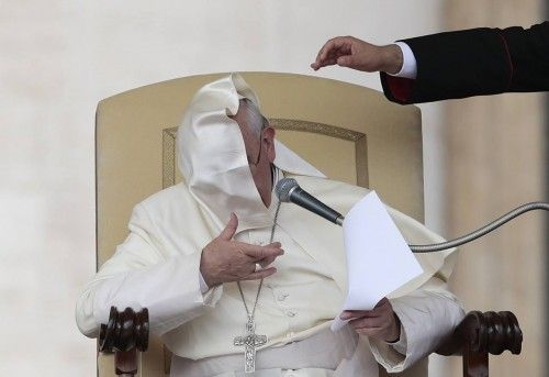 A gust of wind blows Pope Francis' mantle as he leads his Wednesday general audience in Saint Peter's square at the Vatican