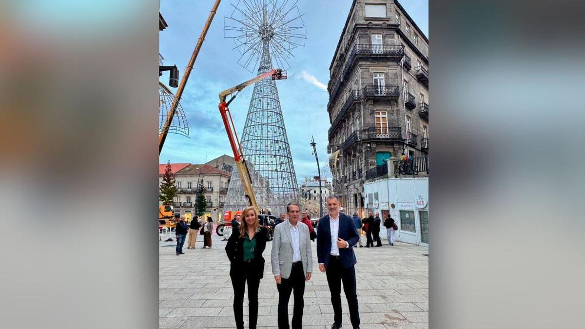 Abel Caballero, junto a los concejales María del Carmen Lago y Ángel Rivas en el árbol gigante de Navidad, con la estrella ya instalada.