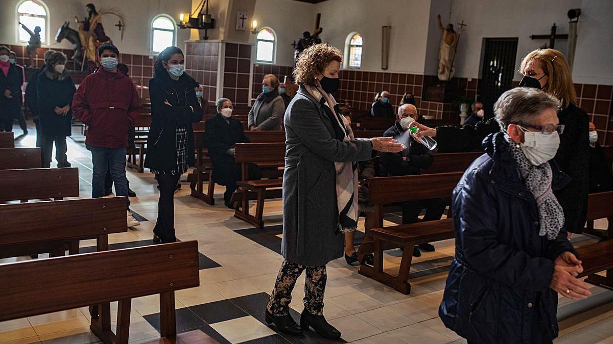 Los fieles acuden a comulgar en la iglesia de Villalpando respetando todas las medidas de seguridad. | Emilio Fraile