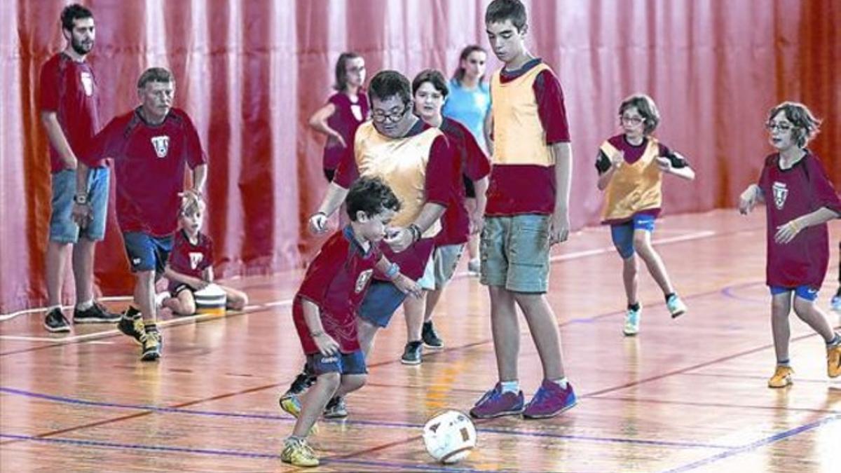 MOTIVADOS PARA SER COMO MESSI. Una quincena de jugadores y jugadoras, de entre 10 y  40 años, entrenan semanalmente en el pabellón deportivo de Vilassar de Mar.