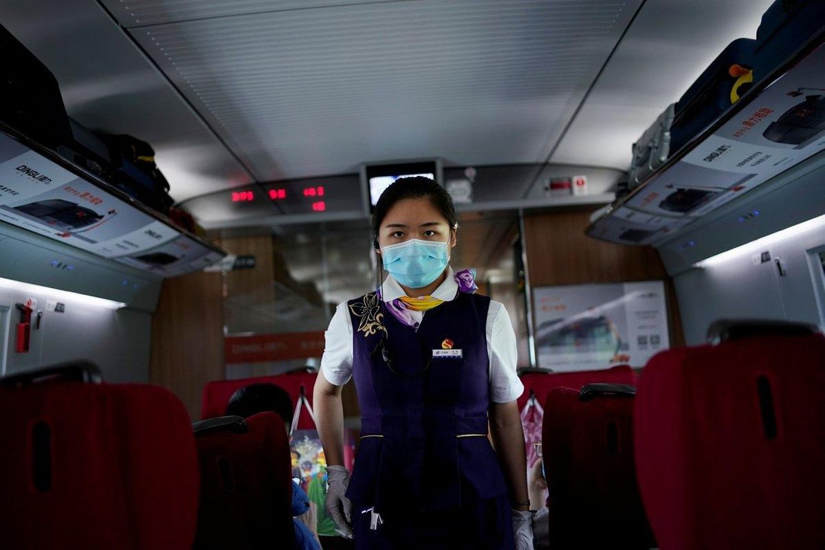 FILE PHOTO: A train staff member walks on a high-speed train at Wuhan Railway Station, in Wuhan, the Chinese city hit the hardest by the coronavirus disease (COVID-19) outbreak, in the Hubei province, China, May 17, 2020. REUTERS/Aly Song/File Photo FILE PHOTO: A train staff member walks on a high-speed train at Wuhan Railway Station, in Wuhan, the Chinese city hit the hardest by the coronavirus disease (COVID-19) outbreak, in the Hubei province, China, May 17, 2020. REUTERS/Aly Song/File Photo