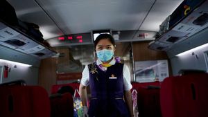 FILE PHOTO: A train staff member walks on a high-speed train at Wuhan Railway Station, in Wuhan, the Chinese city hit the hardest by the coronavirus disease (COVID-19) outbreak, in the Hubei province, China, May 17, 2020. REUTERS/Aly Song/File Photo