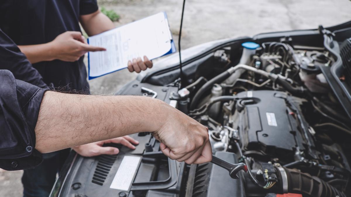 Mecánicos revisando el motor del coche
