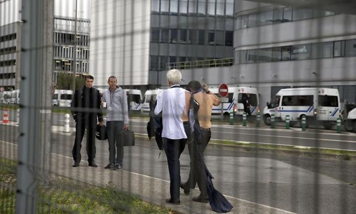 El director d’Air France en Orly, Pierre Plissonnier (esquerra) i el responsable de recursos humans, Xavier Broseta, tots dos sense camisa, s’allunyen dels manifestants.