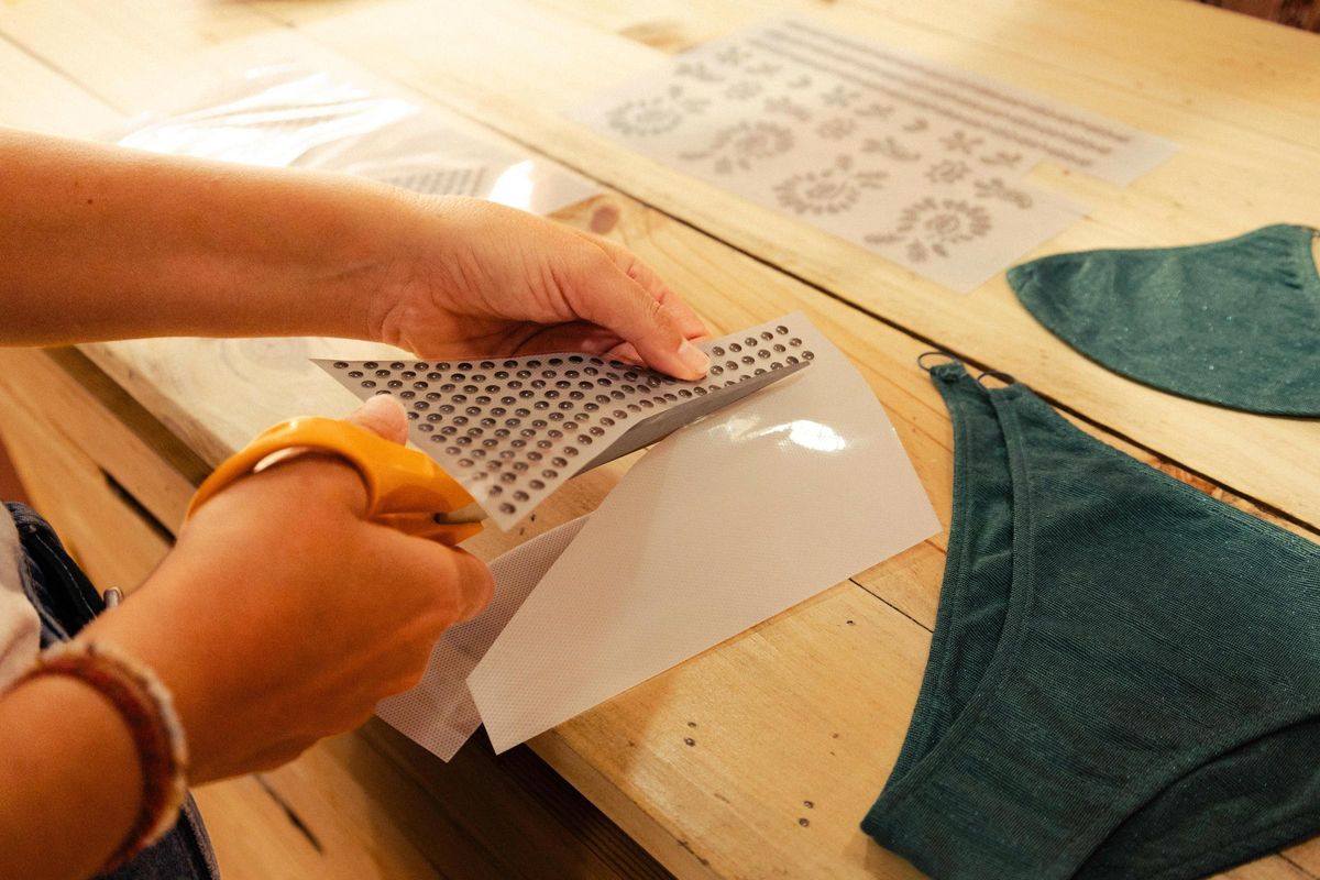 Recortando tachuelas para estampar en el bikini personalizado.