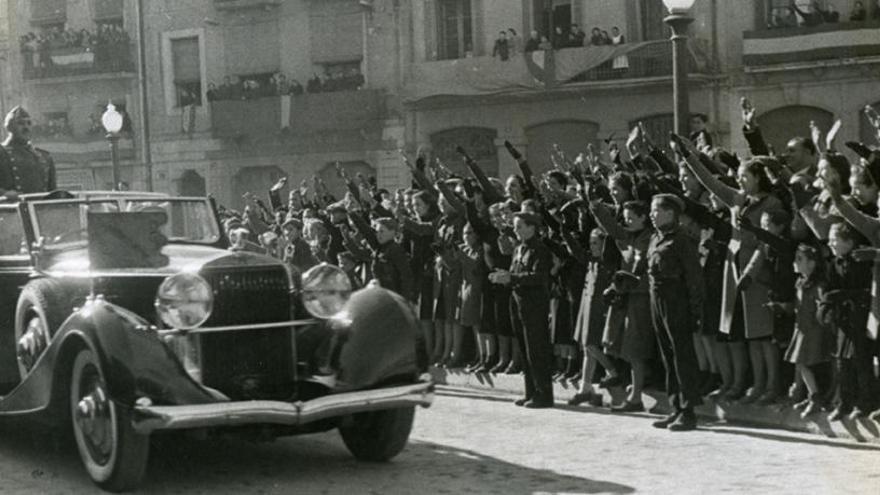 Franco en un cotxe descobert, aclamat per una gentada a la seva arribada a Girona.