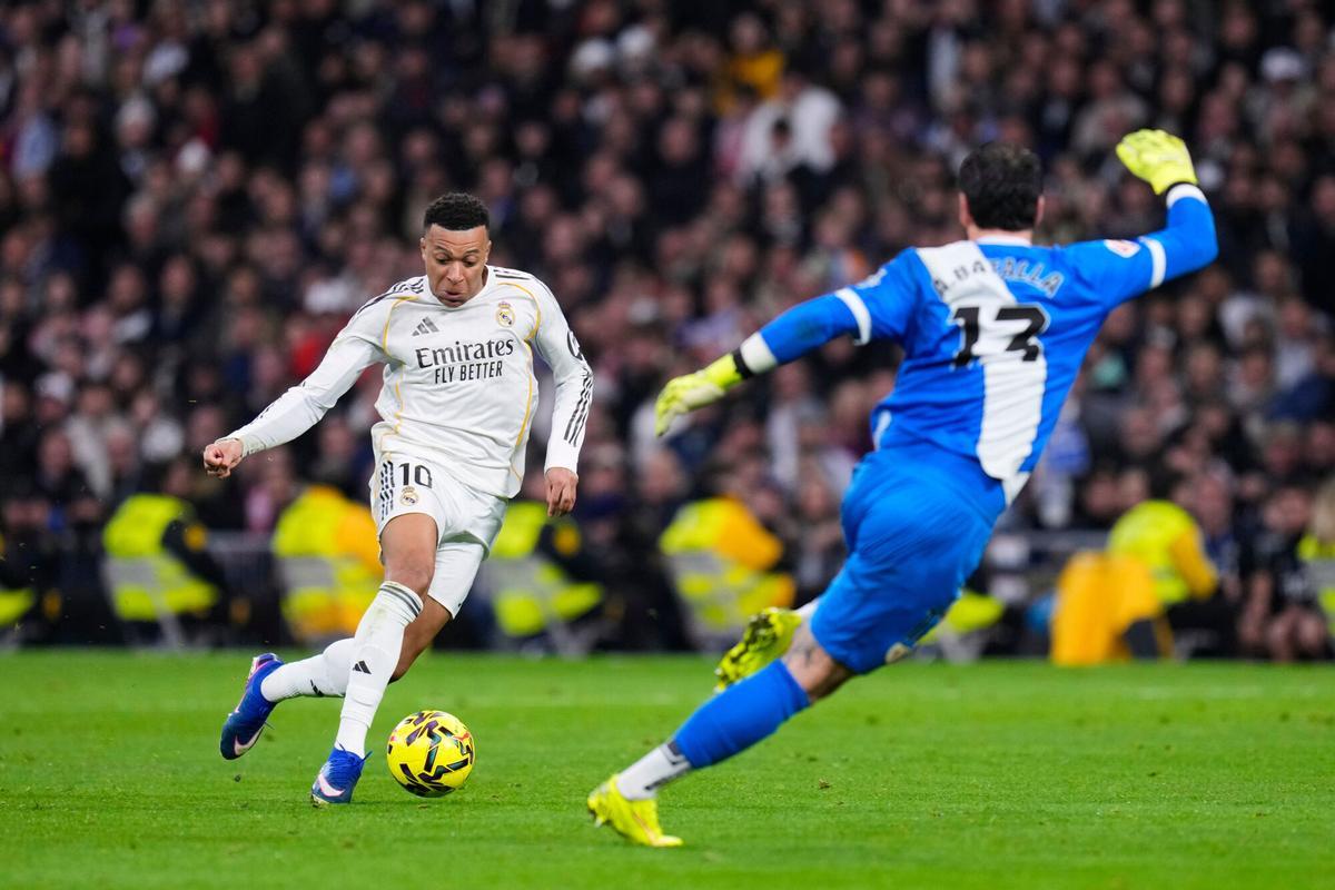 Real Madrid's Kylian Mbappe tries a shot next to Rayo's goalkeeper Augusto Batalla during the Spanish La Liga soccer match between Real Madrid and Rayo Vallecano in Madrid, Spain, Sunday, Feb. 1, 2026. (AP Photo/Manu Fernandez)