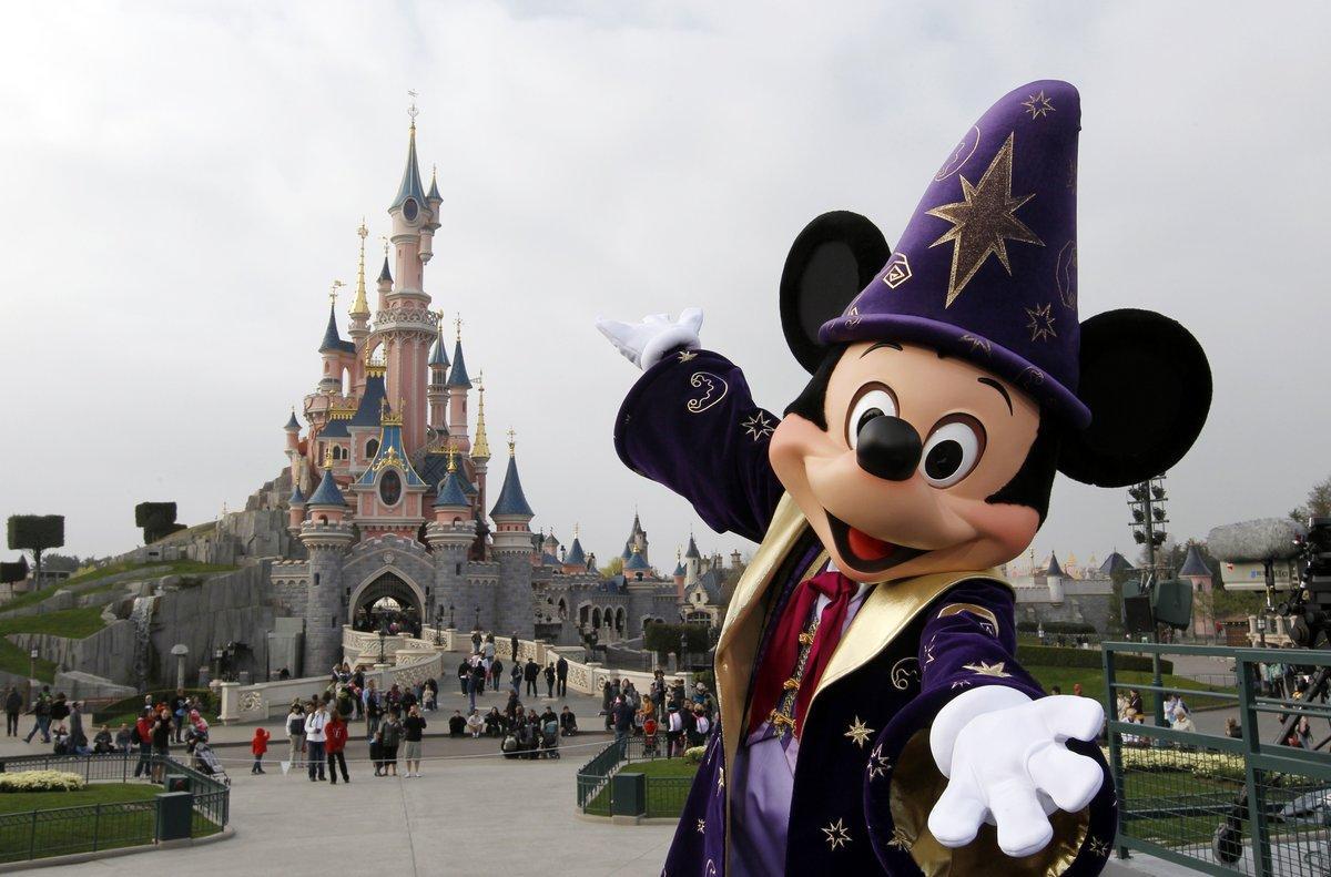 (FILES) - A file photo taken on March 31, 2012 shows Disney character Mickey posing in front of the Sleeping Beauty Castle at Disneyland park as part of the 20th birthday celebrations of the park, in Chessy, near Marne-la-Vallee, outside Paris. Euro Disney, which runs Disneyland Paris, a top European tourist attraction, announced on October 6, 2014 it was receiving a one-billion-euro refinancing package to overcome a crisis after a sharp fall in visitor numbers and spending. Shares in the company plunged by nearly 12.0 percent in initial trading in Paris. The plan includes a cash infusion of 420 million euros ($526 million) by the parent company, US-based Walt Disney Co, and a conversion of 600 million euros of debt owed to Walt Disney into equity, the company said in a statement.  AFP PHOTO / THOMAS SAMSON