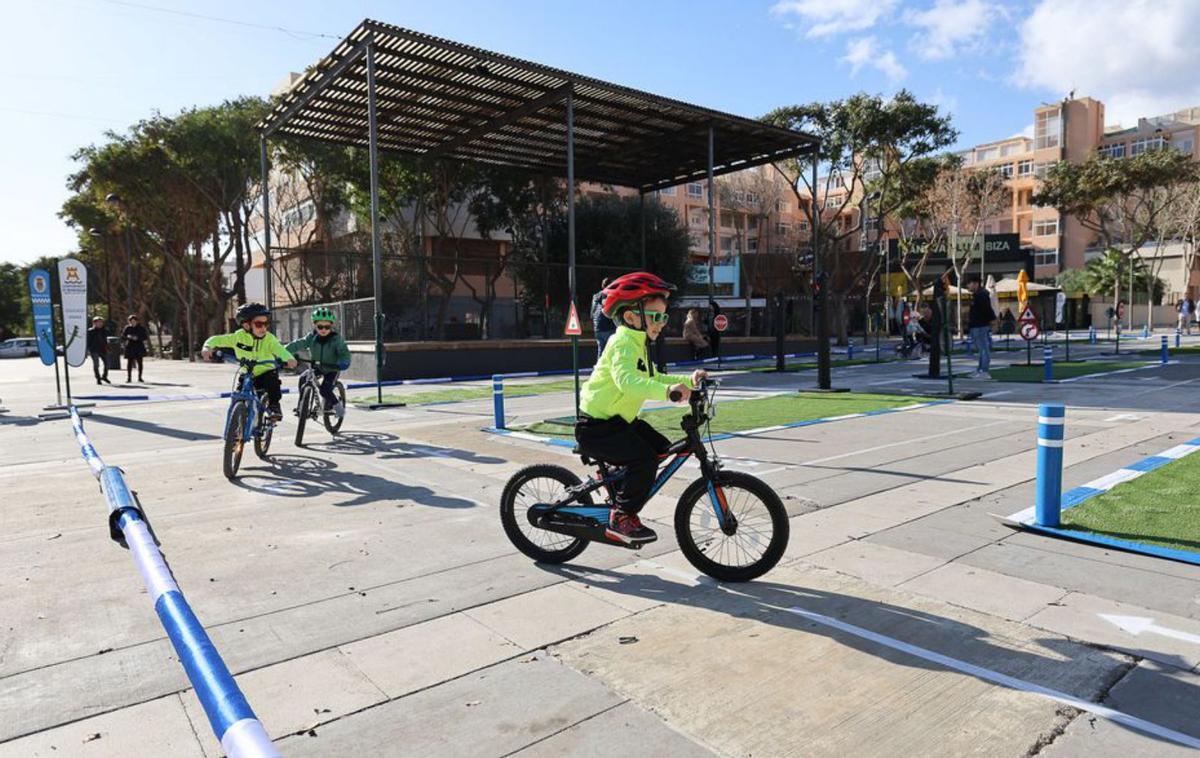 Un niño pedalea protegido con casco y gafas de sol. | TONI ESCOBAR