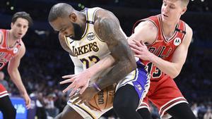 Chicago Bulls guard Kevin Huerter (13) tries to steal the ball away from Los Angeles Lakers forward LeBron James (23) in the second half of an NBA basketball game Saturday, March 22, 2025, in Los Angeles. (AP Photo/Wally Skalij)