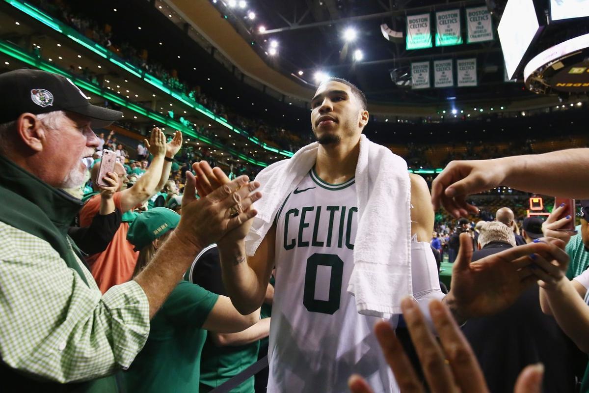 BOSTON, MA - MAY 23: Jayson Tatum #0 of the Boston Celtics high fives fans after defeating the Cleveland Cavaliers 96-83 in Game Five of the 2018 NBA Eastern Conference Finals at TD Garden on May 23, 2018 in Boston, Massachusetts. NOTE TO USER: User expressly acknowledges and agrees that, by downloading and or using this photograph, User is consenting to the terms and conditions of the Getty Images License Agreement.   Adam Glanzman/Getty Images/AFP