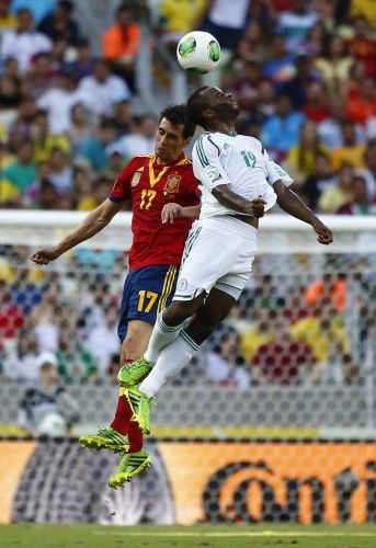 Spain's Arbeloa and Nigeria's Mba fight for the ball during their Confederations Cup Group B soccer match at the Estadio Castelao in Fortaleza