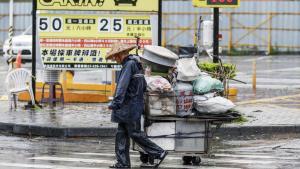 Un vendedor callejero en Kaohsiung city, Taiwan, bajo las lluvias del tifón Krathon