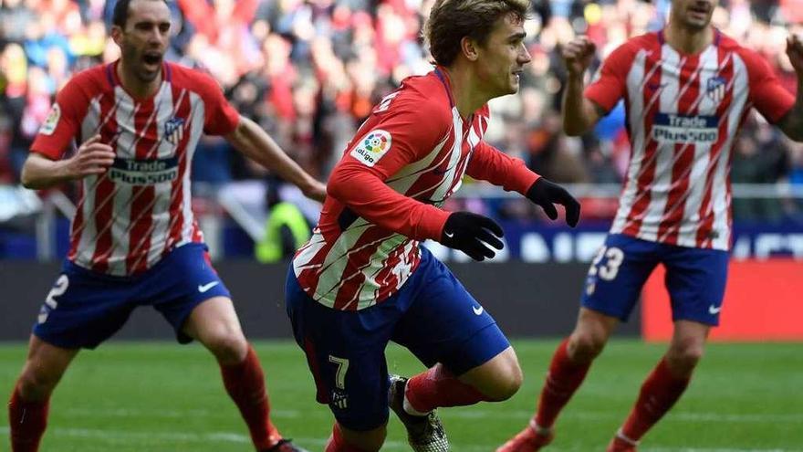 Griezmann, tras marcar su gol en el partido de ayer, con Godín y Vitolo.