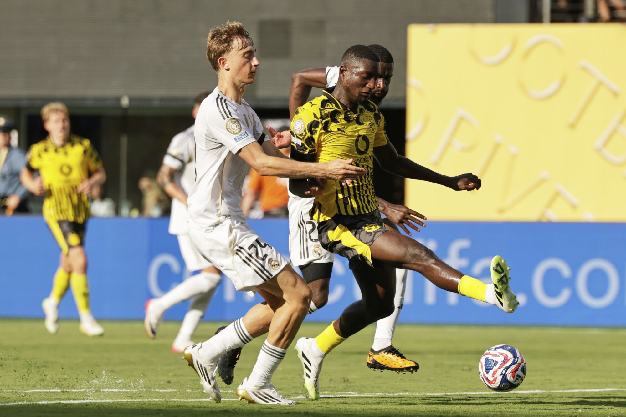 Borussia Dortmund's Serhou Guirassy, right, is fouled by Real Madrid's Dean Huijsen during the Club World Cup quarterfinal soccer match between Real Madrid and Borussia Dortmund in East Rutherford, N.J., Saturday, July 5, 2025. (AP Photo/Adam Hunger)
