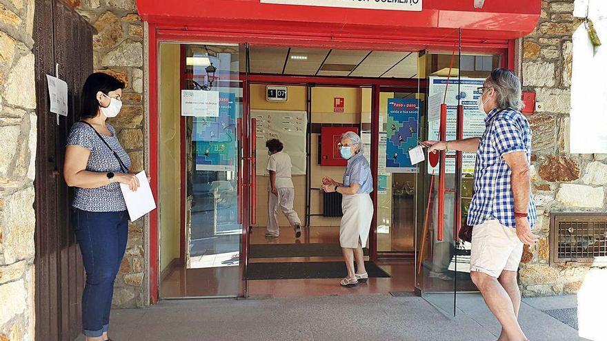 Pacientes esperan a ser atendidos a las puertas de un centro de salud, este verano.