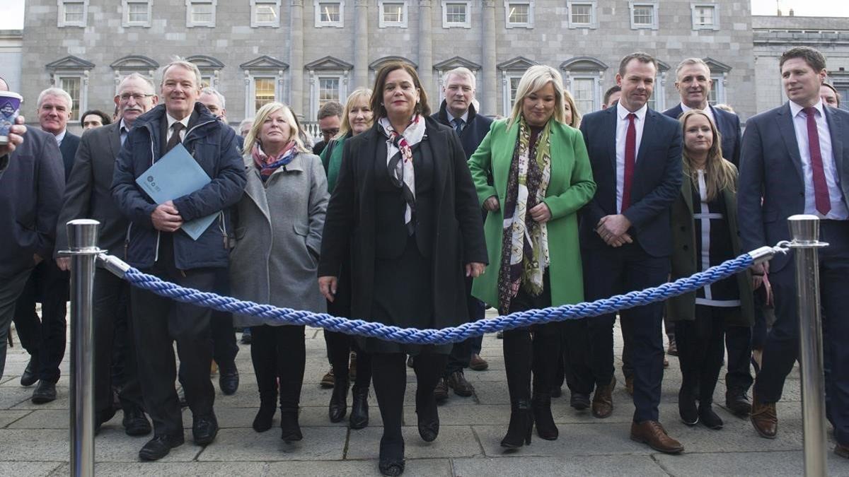 La líder del Sinn Féin, Mary Lou McDonald, posa con los nuevos diputados del partido en el exterior del Parlamento irlandés, este jueves.
