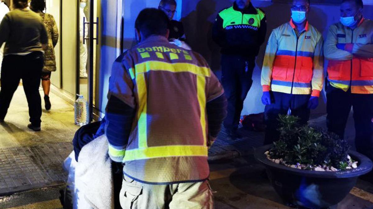 Un bombero desaloja a un anciano durante el incendio en la residencia Vilamontgrí.