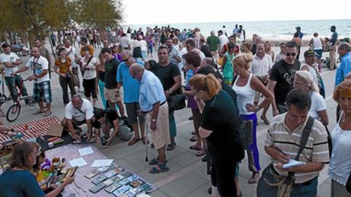 Comerciantes de Calafell exponen su mercancía sobre mantas frente a los manteros, ayer.