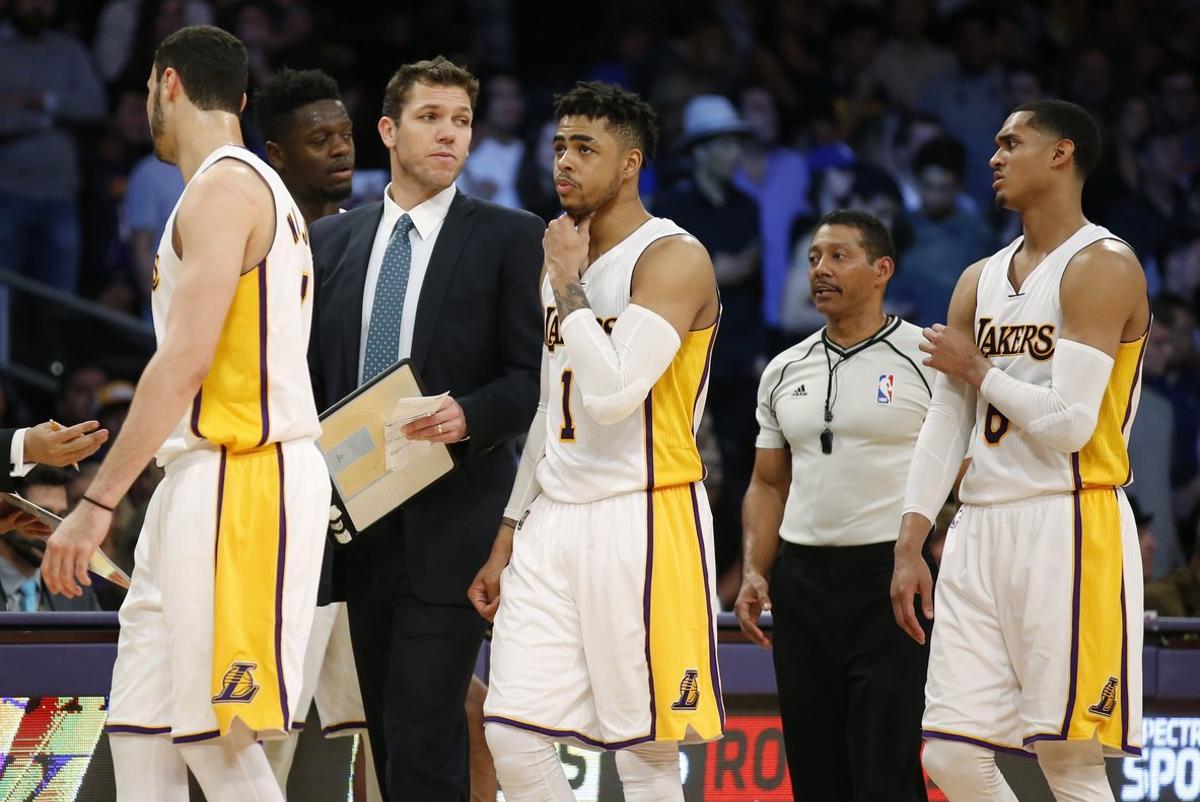 Los Angeles Lakers head coach Luke Walton  third left  walks with team members including  from left  forward Larry Nance Jr   forward Julius Randle  guard D Angelo Russell and guard Jordan Clarkson during the second half of an NBA basketball game  Sunday  March 12  2017  in Los Angeles  The 76ers won 118-116   AP Photo Danny Moloshok