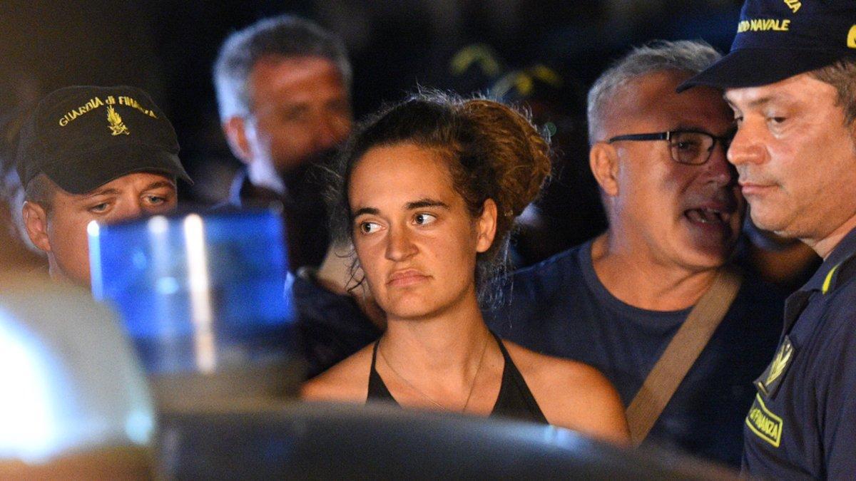 Carola Rackete, the 31-year-old Sea-Watch 3 captain, is escorted off the ship by police and taken away for questioning, in Lampedusa, Italy June 29, 2019. REUTERS/Guglielmo Mangiapane