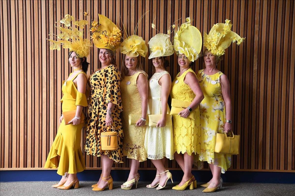 Señoras vestidas de amarillo asisten al segundo día de las carrersa de caballos Royal Ascot, al oeste de Londres.