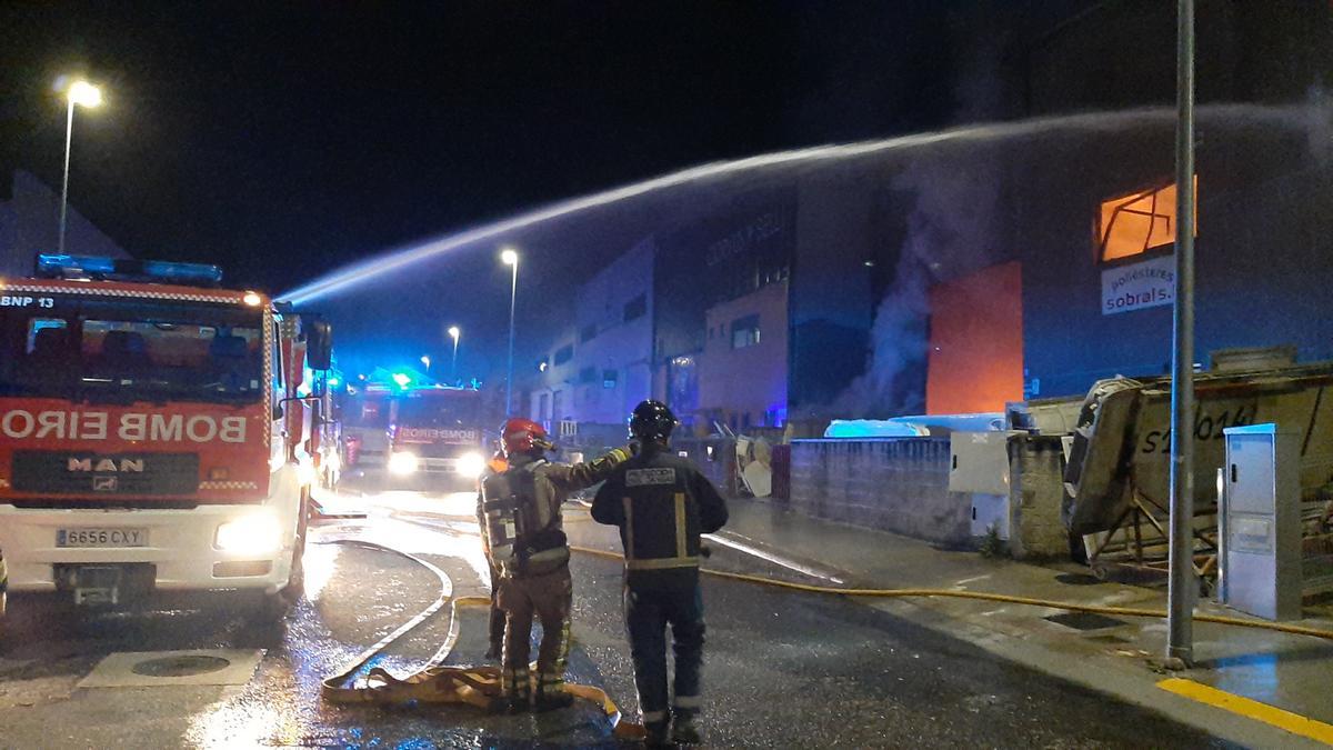 Los bomberos intentando sofocar el fuego y refrescando las naves colindantes.