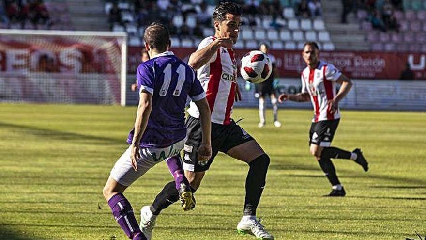 Dani Hernández solventa la presión ante un jugador del Briviesca.