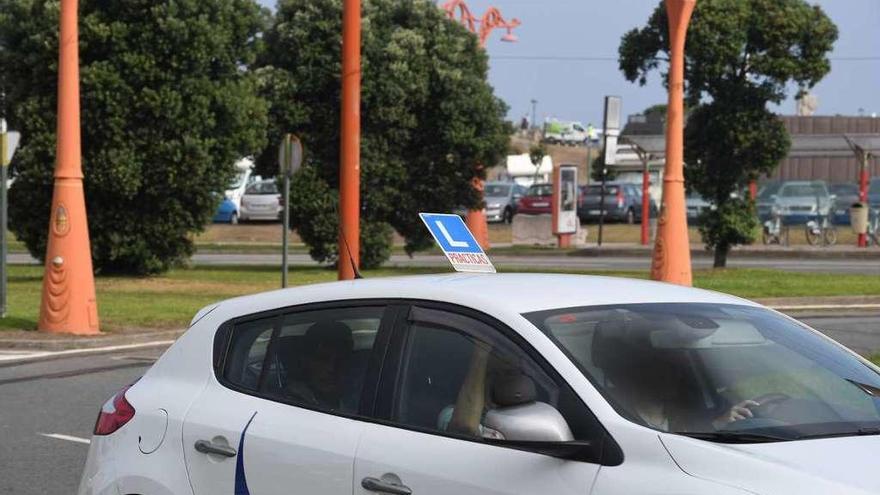 Un coche de autoescuela realiza clases prácticas en A Coruña.