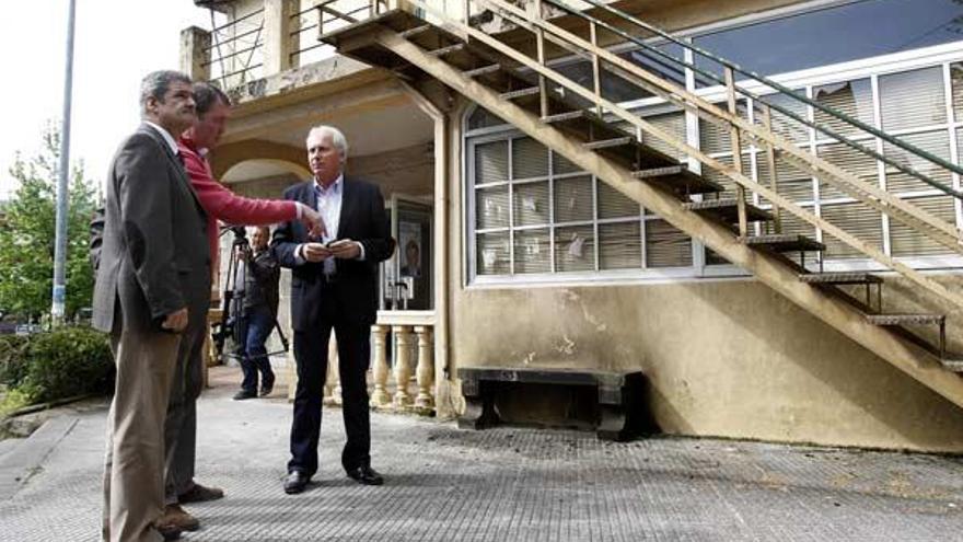 El alcalde, a la izquierda, un afiliado y el presidente local del PP, junto a la zona de la deflagración.