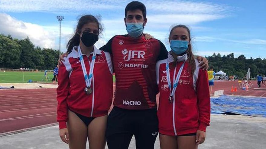 Marta Lázara y Antía Framiñán flanquean a su entrenador Nacho Castro tras recibir sus medallas.