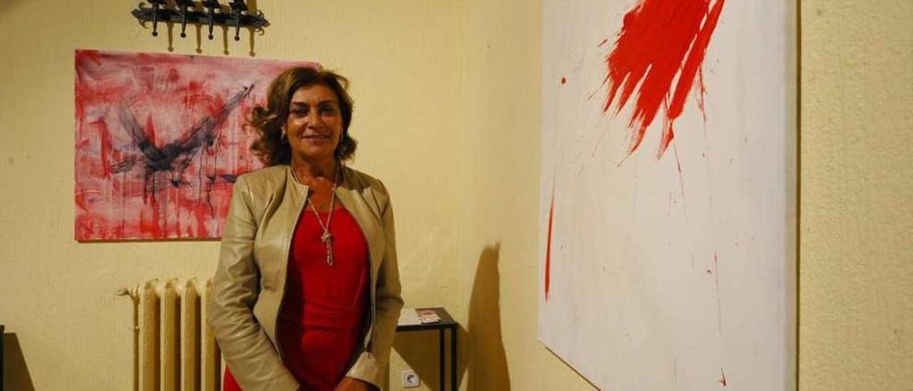 Adela Rodríguez posa junto a una de sus pinturas ayer en la inauguración de &quot;Mergullándome&quot;. // J. Regal