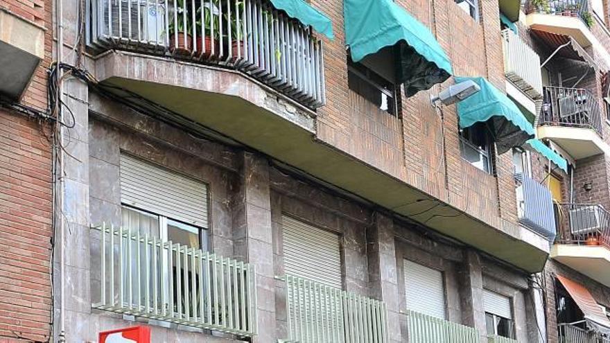 A la izquierda, uno de los balcones donde se desprendieron los cascotes; a la derecha, la zona de aparcamiento evacuada por la grúa.