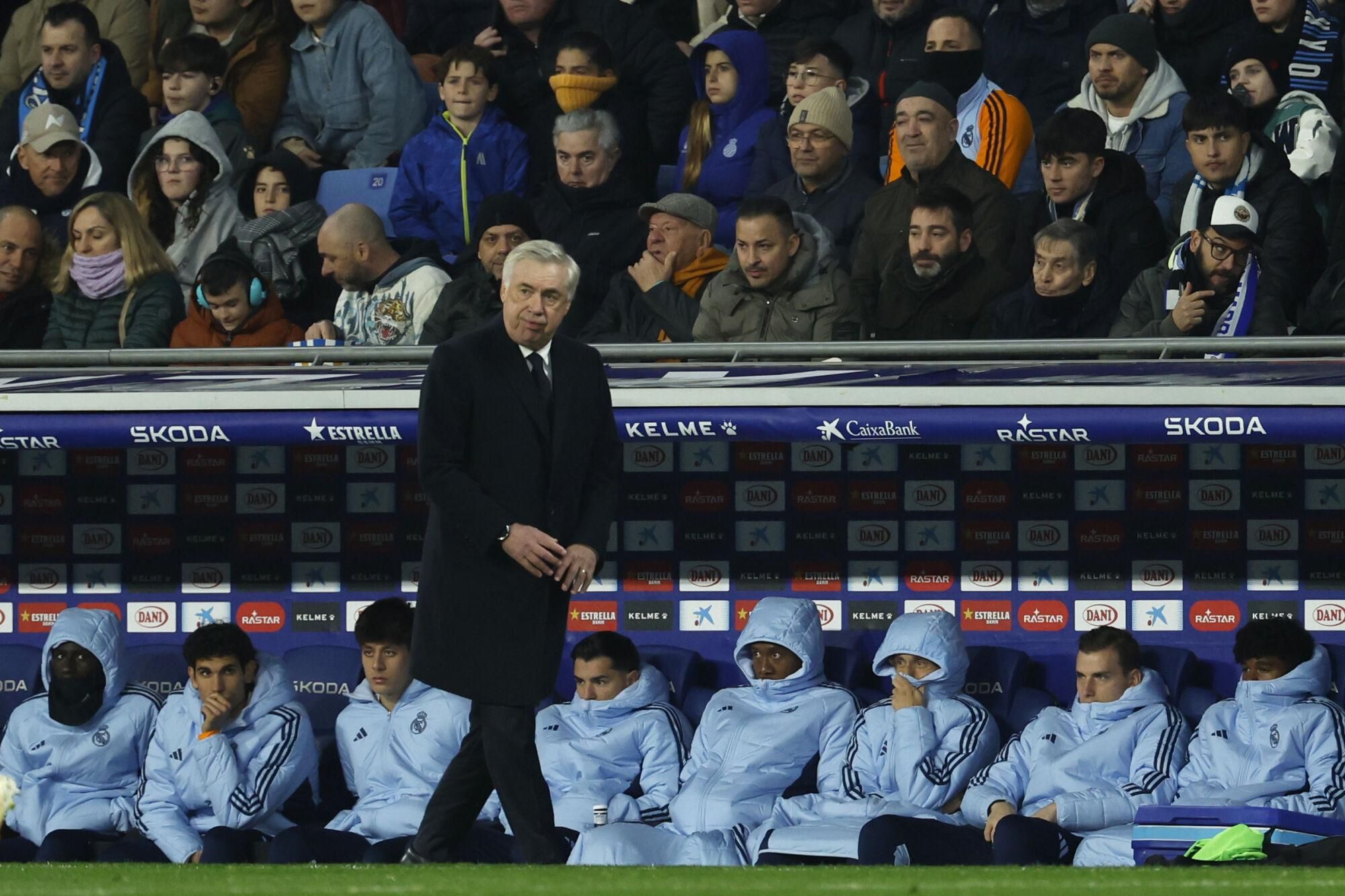 Real Madrid's head coach Carlo Ancelotti watches the play in front of the substitutes bench during a Spanish La Liga soccer match between Espanyol and Real Madrid at the Lluis Companys Olympic Stadium in Barcelona, Spain, Saturday Feb.1, 2025. (AP Photo/Joan Monfort)