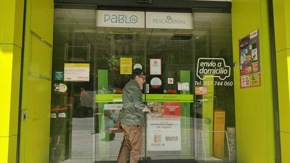 Un hombre intenta entrar en un supermercado, cerrado tras el apagón.
