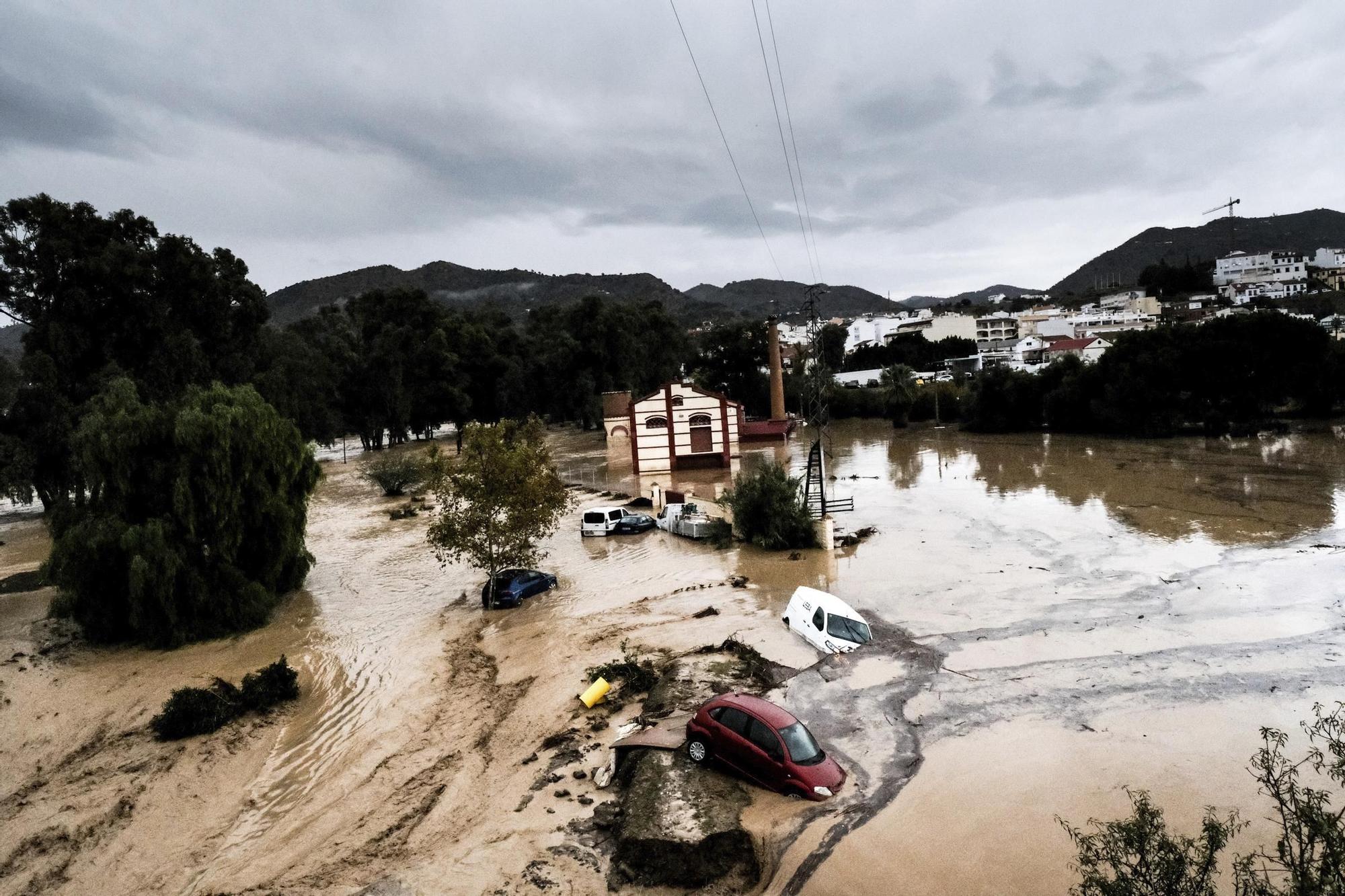 Cars are swept away by the water, after floods preceded by heavy rains caused the river to overflow its banks in the town of Alora, Malaga, Tuesday, Oct. 29, 2024. (AP Photo/Gregorio Marrero)