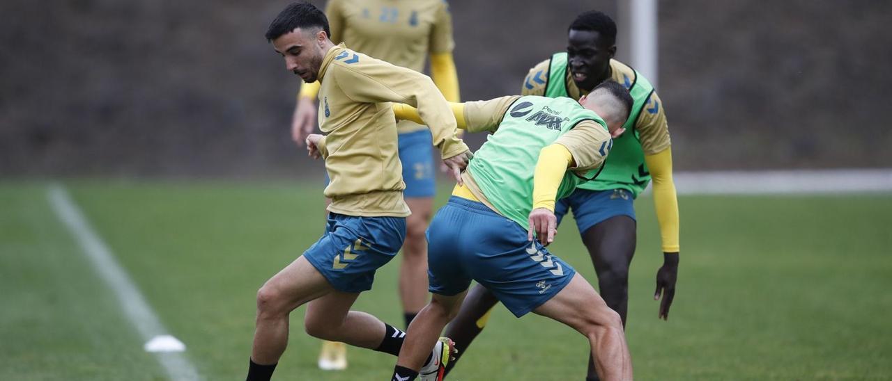 Rober González, presionado por Sergi Cardona y Clau Mendes –ambos con peto verde– durante el entrenamiento del pasado martes en Barranco Seco. | | LP/DLP