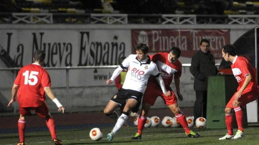 Armando Invernón se lleva el balón en una acción del Caudal-Marino disputado ayer en el Hermanos Antuña.