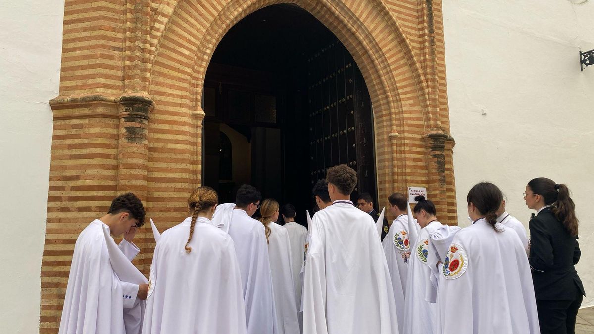 Nazarenos de La Paz a la espera del reparto de cirios.