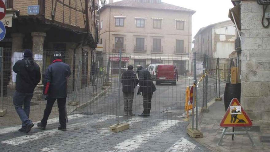 Técnicos repasan las obras que está previsto acometer en la plaza, ante la mirada de dos vecinos. Foto