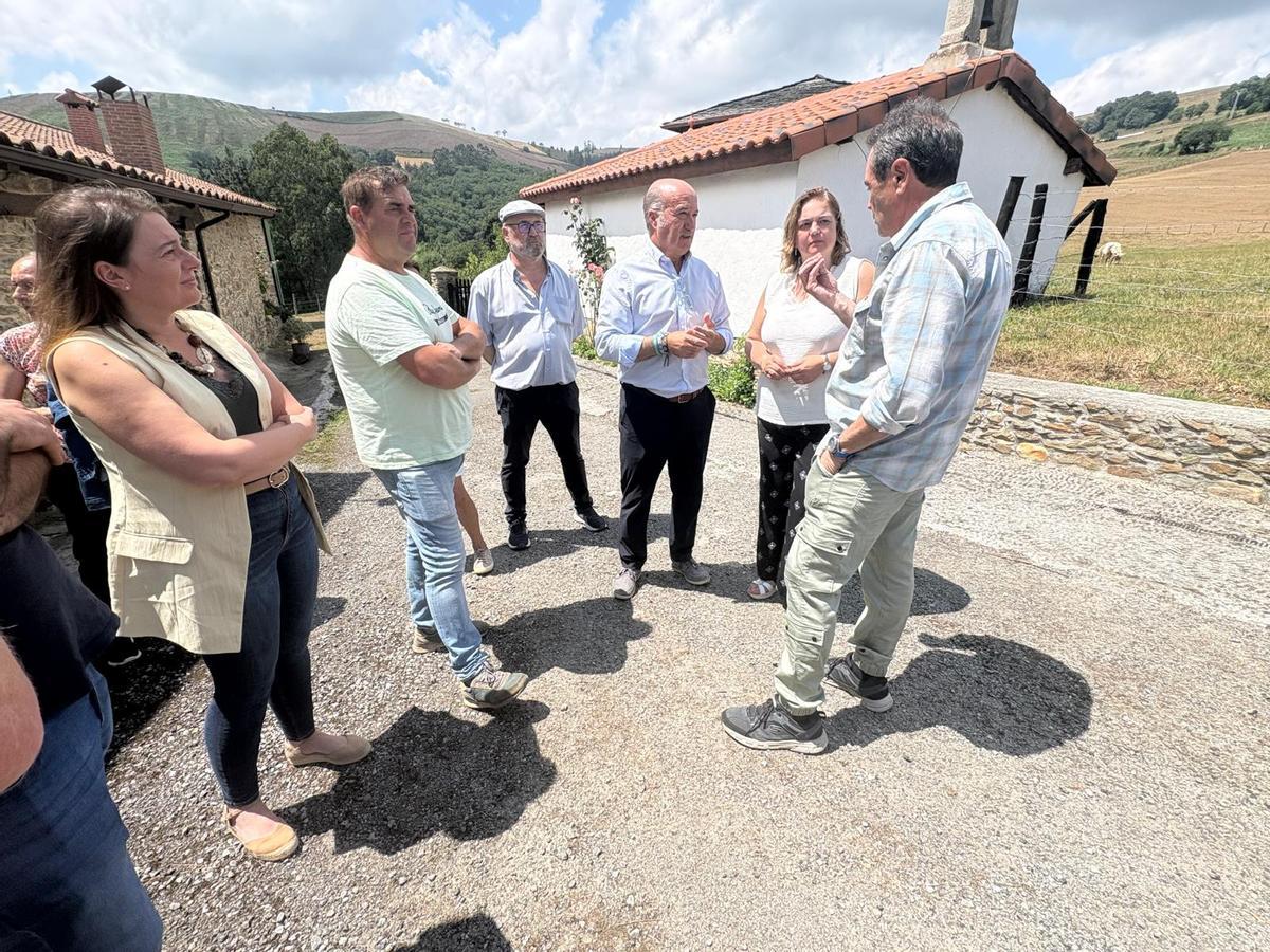 Montse Fernández y Luis Venta, segunda y tercero por la derecha, hablan con los vecinos de Folgueras de Cornás.