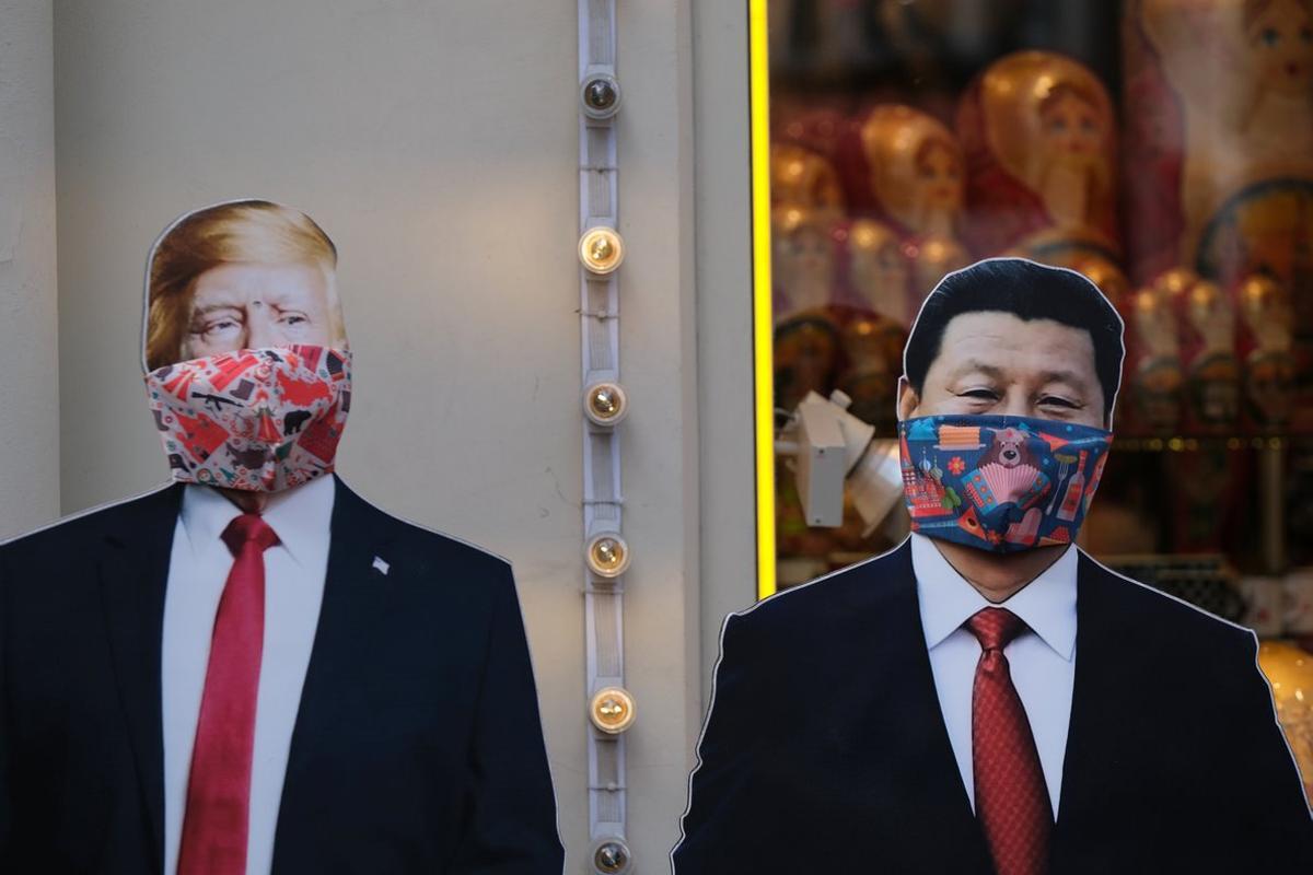 A view shows cardboard cutouts, displaying images of U.S. President Donald Trump and Chinese President Xi Jinping, with protective masks widely used as a preventive measure against coronavirus disease (COVID-19), near a gift shop in Moscow, Russia March 23, 2020. REUTERS/Evgenia Novozhenina