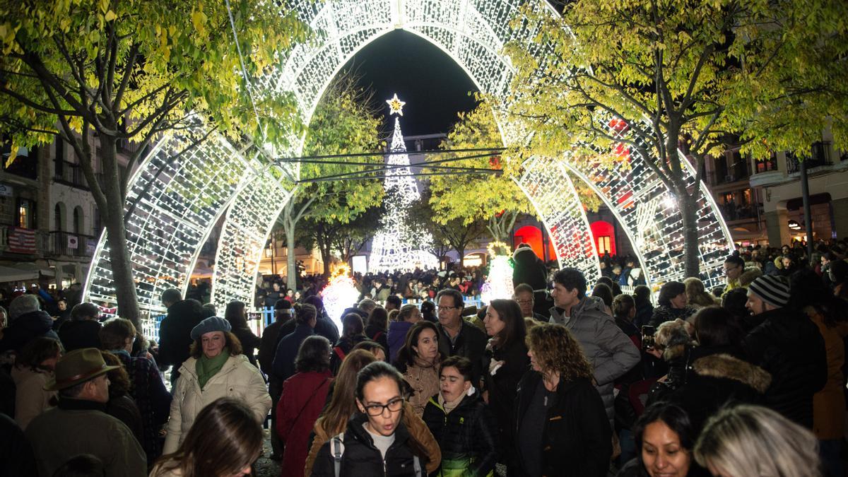 Iluminación navideña encendida en Plasencia, en una plaza Mayor a rebosar.