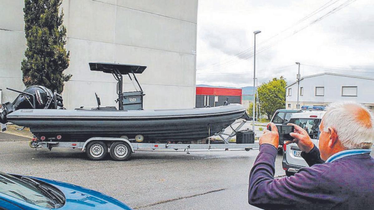 Un hombre fotografía una de las lanchas que se guardaban en la nave de Vilanova. |  // Iñaki Abella