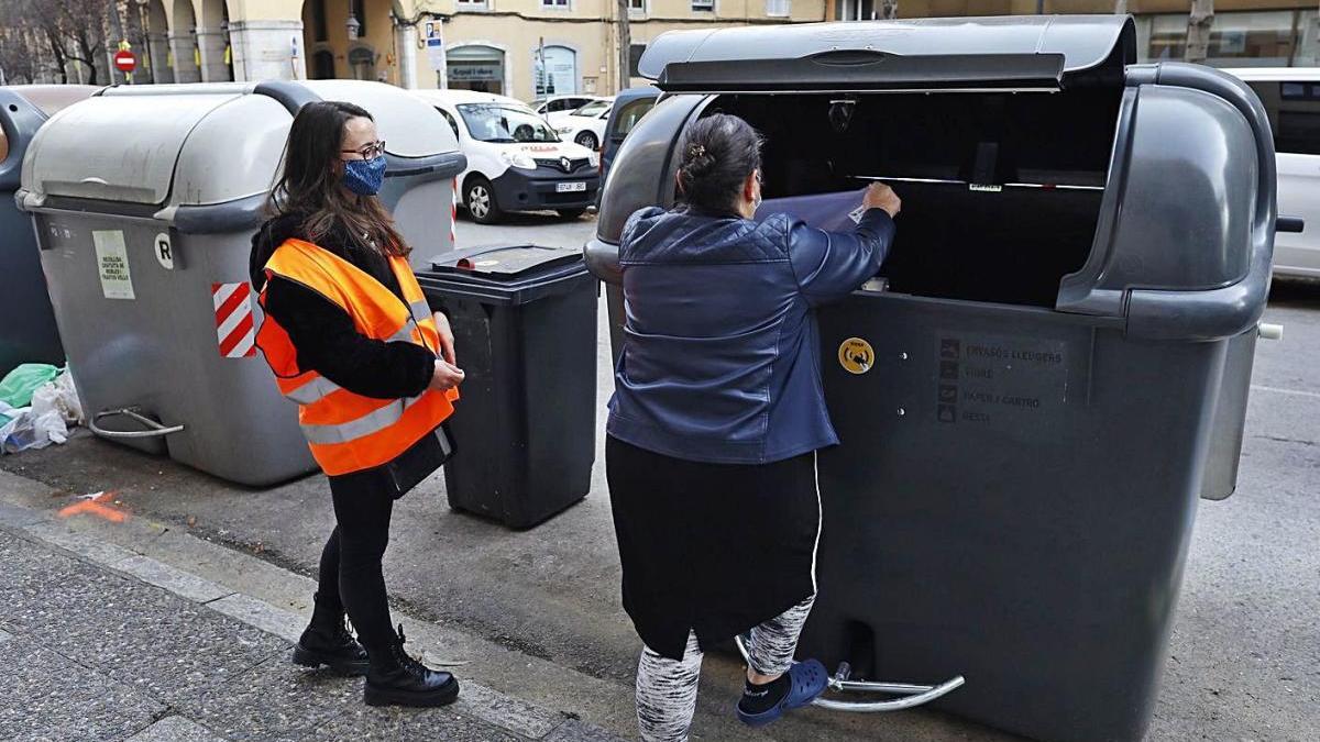 Una informadora a peu de contenidors la setmana passada a l’avinguda Sant Francesc de Girona.