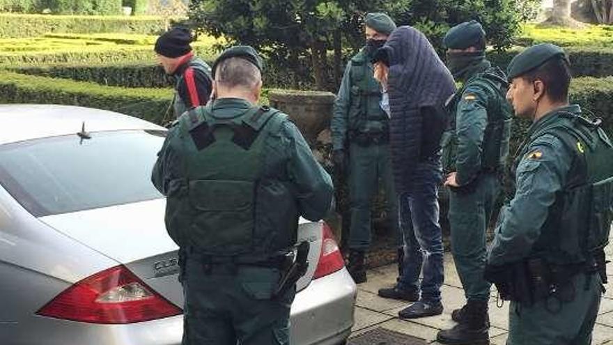 La Guardia Civil con un detenido durante un registro. // Iñaki Osorio