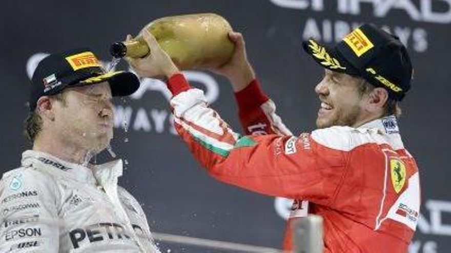 Sebastian Vettel, el darrer campió alemany fins ahir, ruixa de xampany Nico Rosberg al podi.