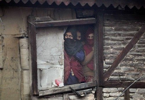 Kashmiri Muslim women watch a a Muharram procession a day before Ashoura in Srinagar