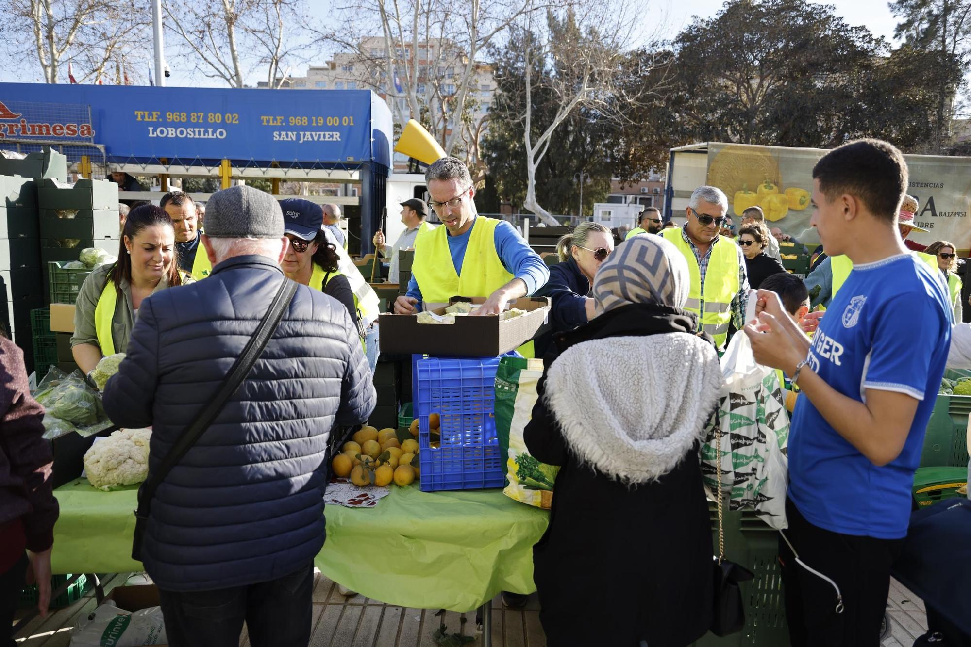 Las imágenes del plante de los agricultores frente a la Asamblea, donde han repartido frutas y hortalizas